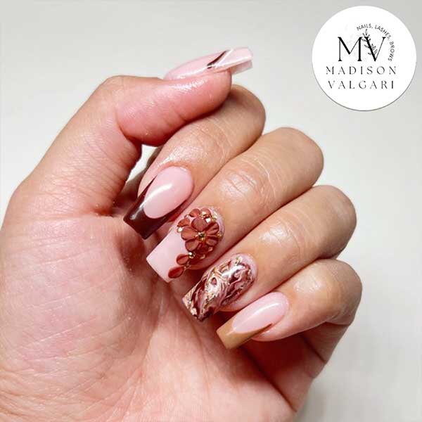 Blush nails with a burgundy French tip, three dimensional flowers and marble art