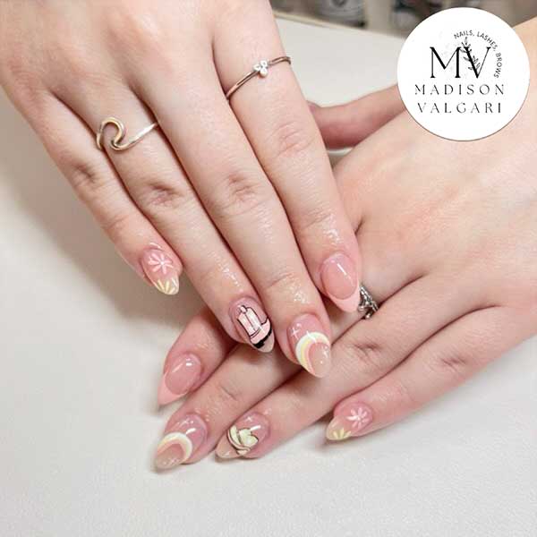 Soft pink nails with pastel French tips and tiny hand painted designs
