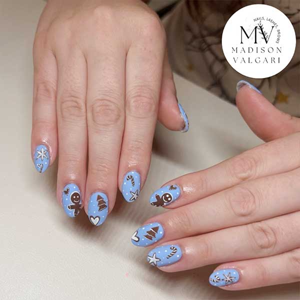 Powder blue holiday nails with hand painted gingerbread figures, snowflakes and Christmas trees